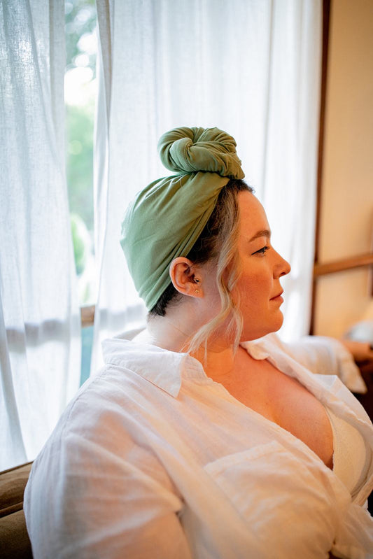 close up shot of woman wearing the Capillum Hair wrap in green