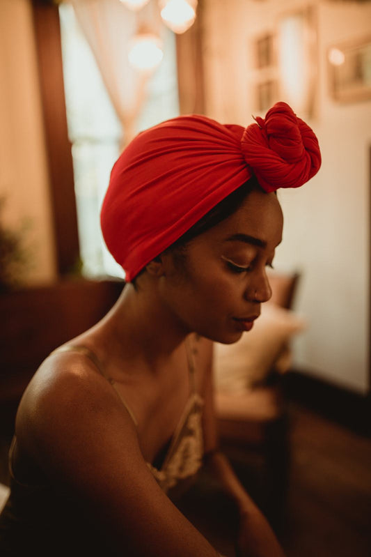 woman in a satin dress rapidly dries her hair with a Capillum Hair Towel