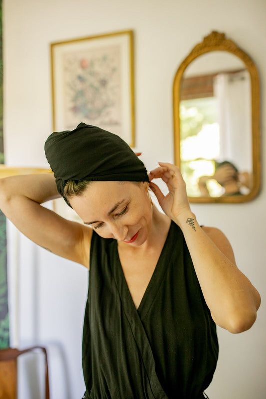 woman adjust her Capillum hair towel in black.