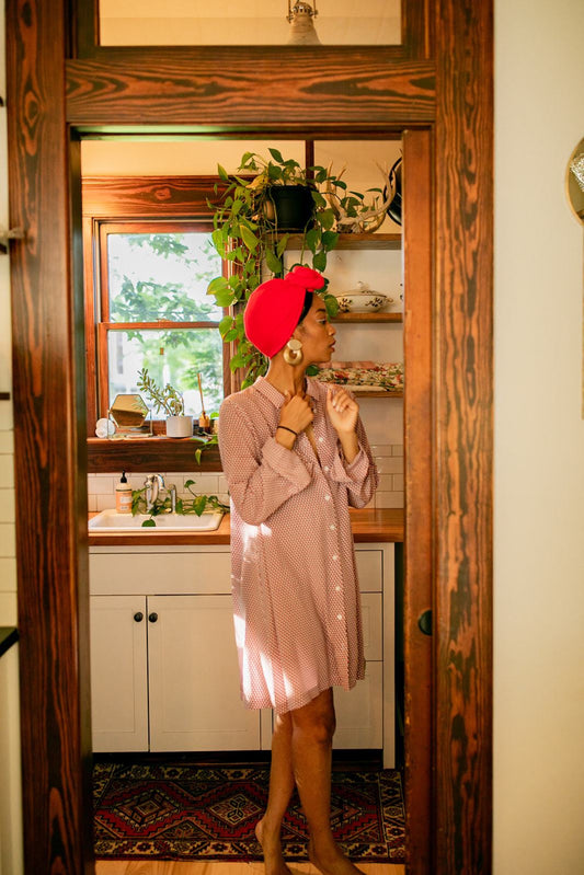 woman stands in doorway protecting her hair with a bamboo hair towel by Capillum