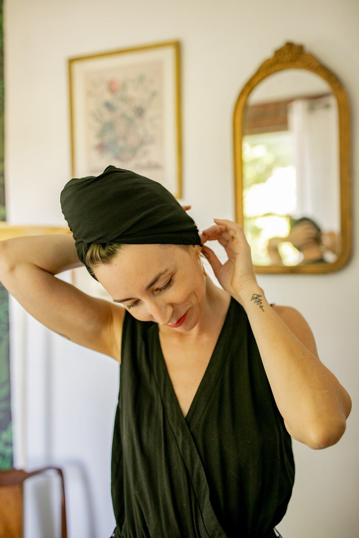 woman adjust her Capillum hair towel in black. 